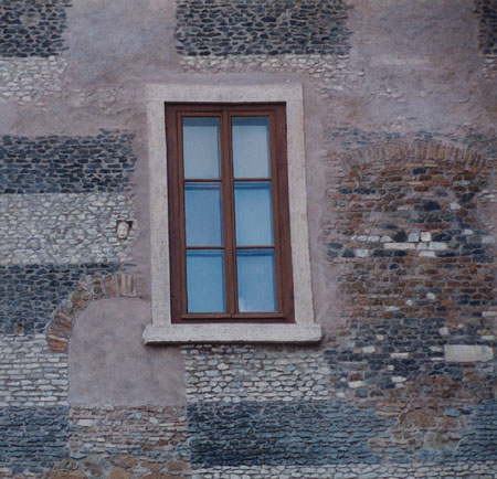 face emerging from a building